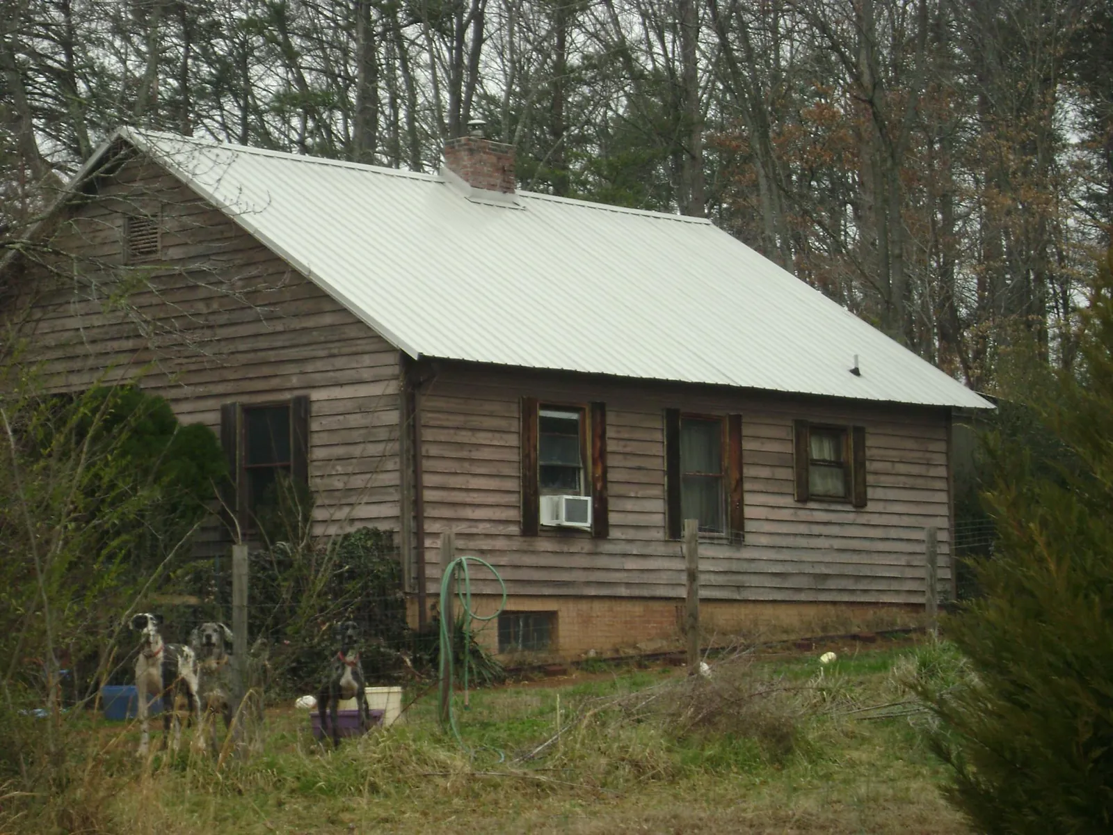 White metal roof on an old wood sided farmhouse, from a Metal Roof Installation job in Gardner